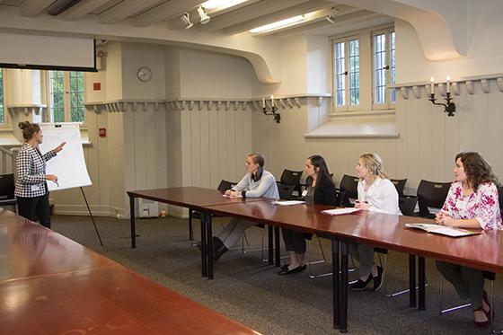 Photo of a woman giving a presentation to a small group of women